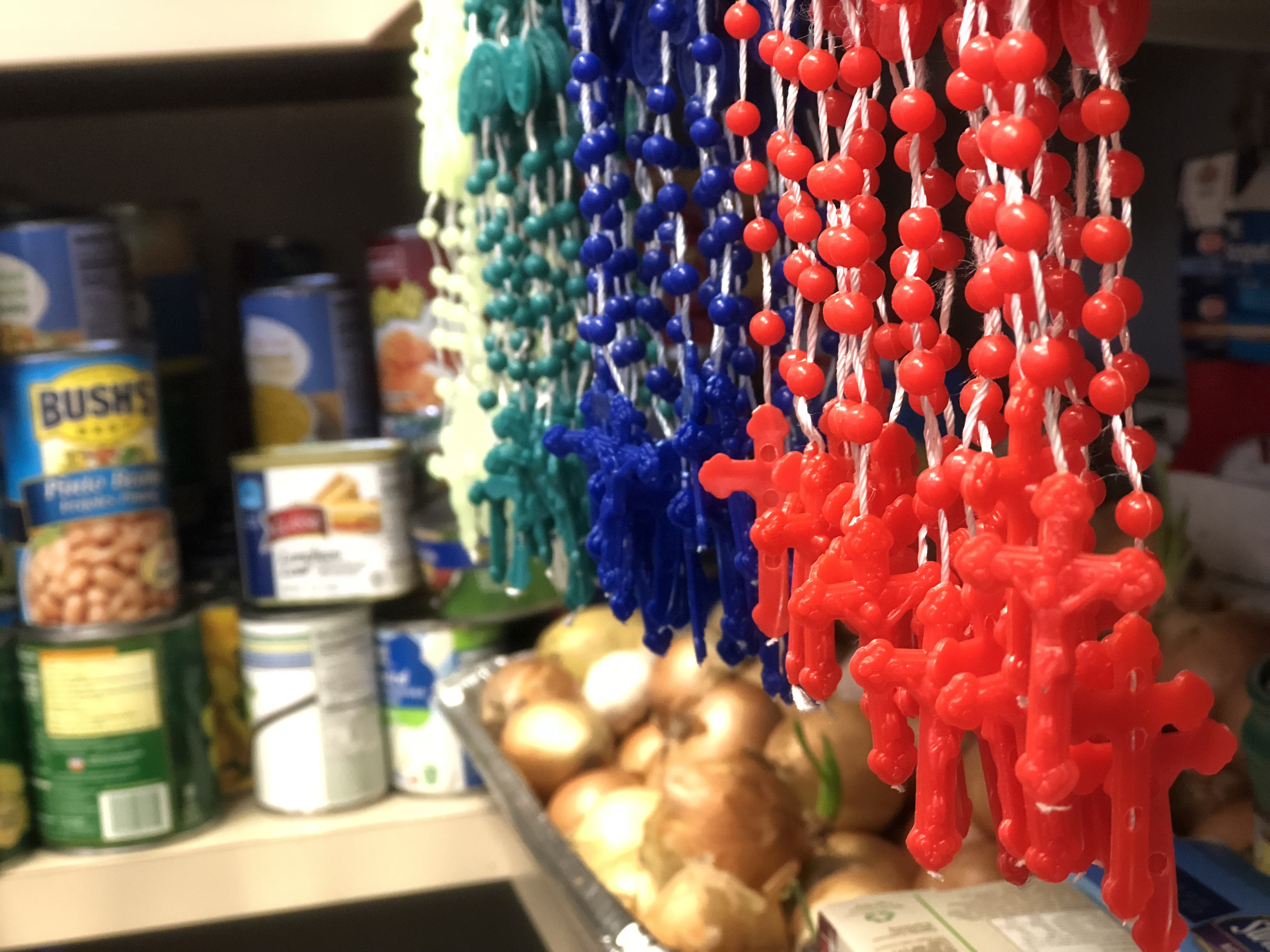 rosaries hanging in a food pantry in san antonio